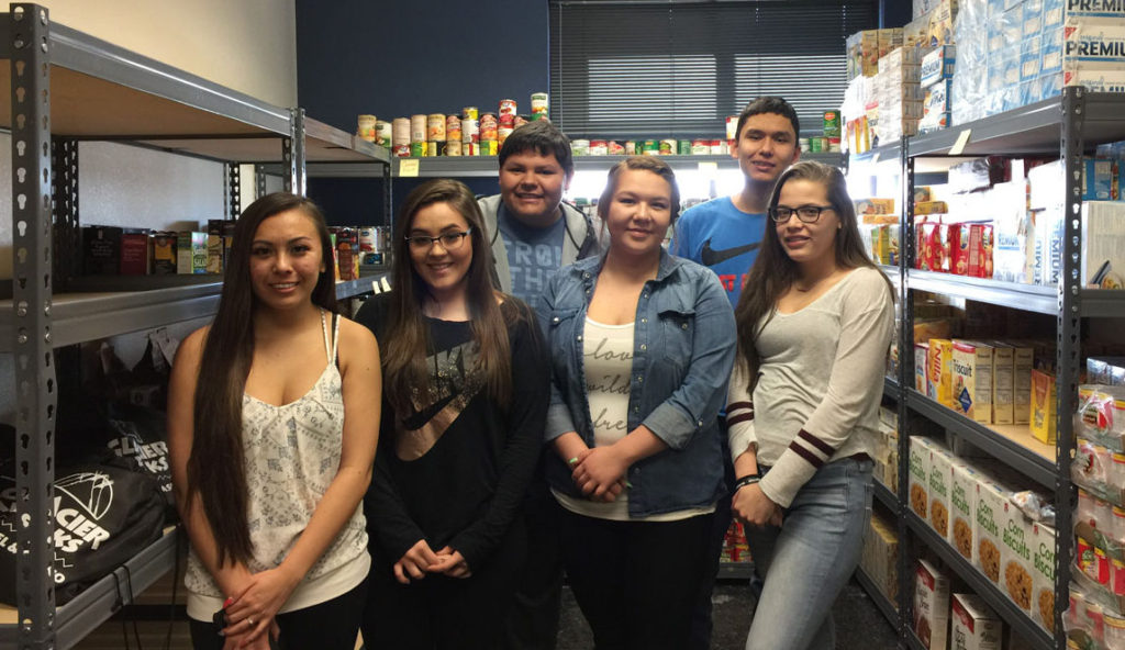 Browning High School Students in local food bank pantry