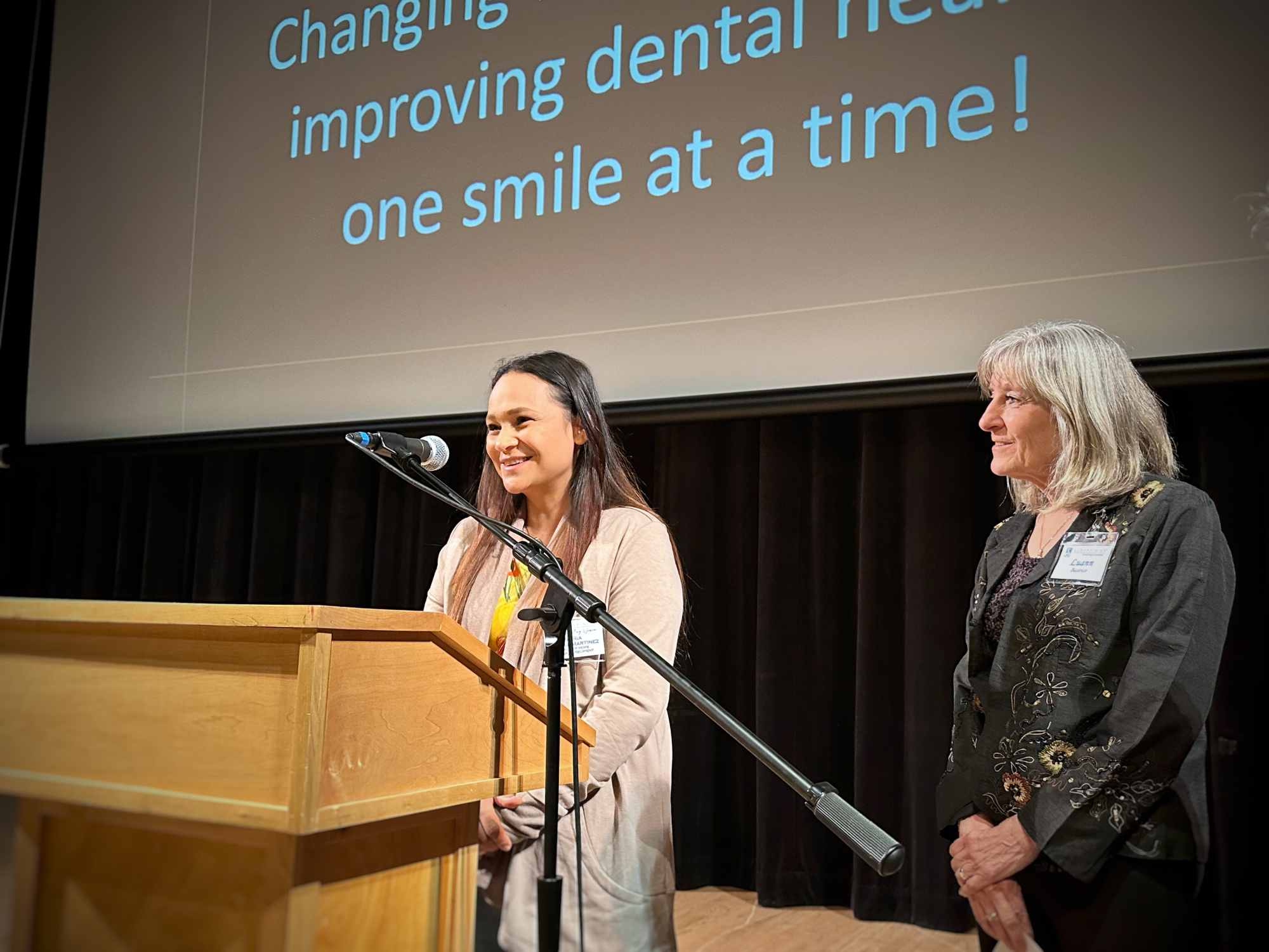 LuAnn Basirico, chair of the Smile of Hope committee with Maria Medina, a recipient of dental care.